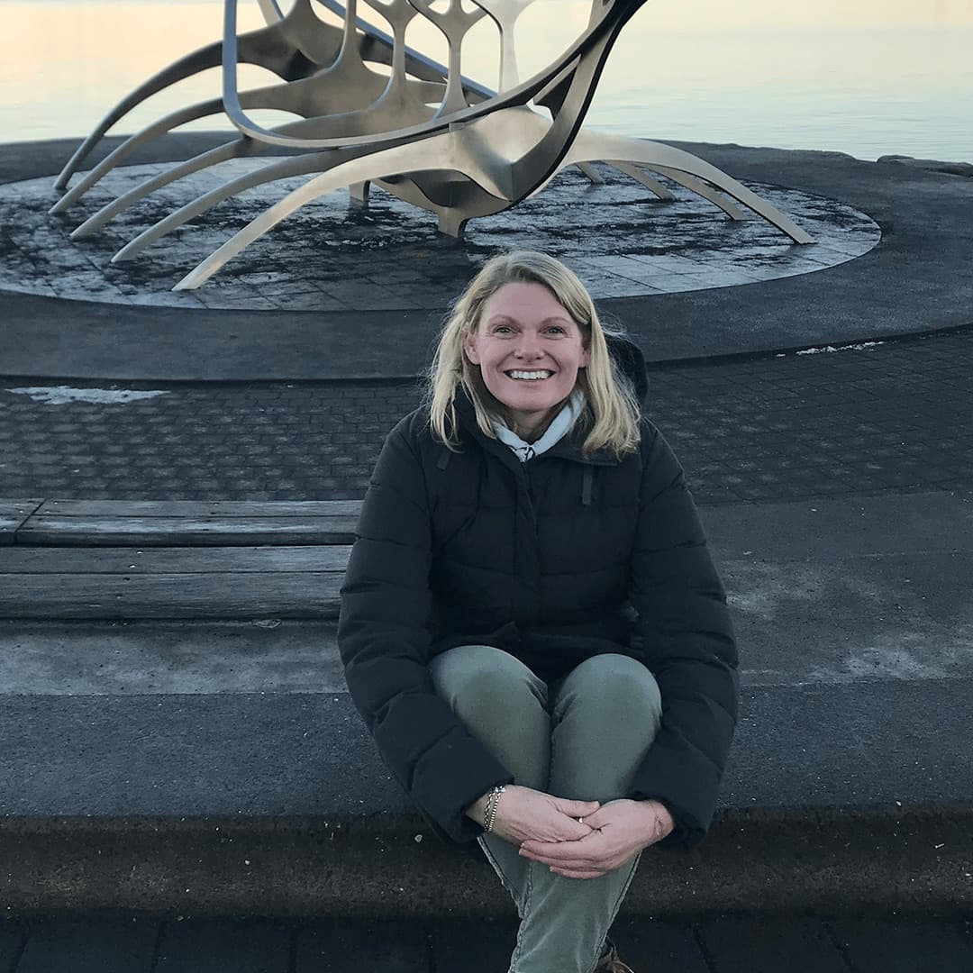 Portrait of Michele Duncan sitting by a harbour