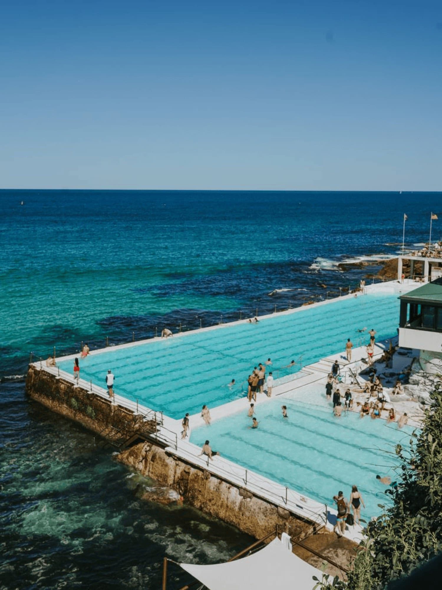 A seaside swimming pool carved into the rocks above the ocean